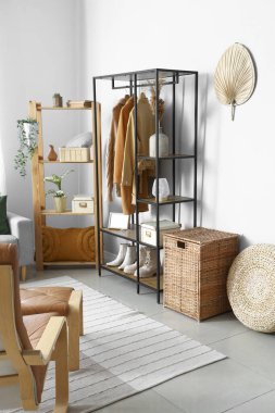 Rafların ve kıyafetlerin olduğu aydınlatma odasının içinde.