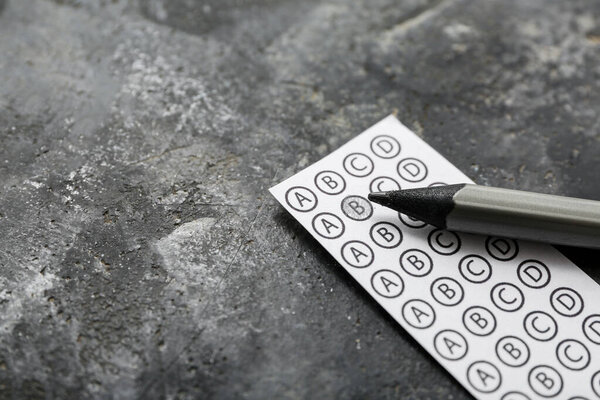 Quiz form with pencil on grunge black background