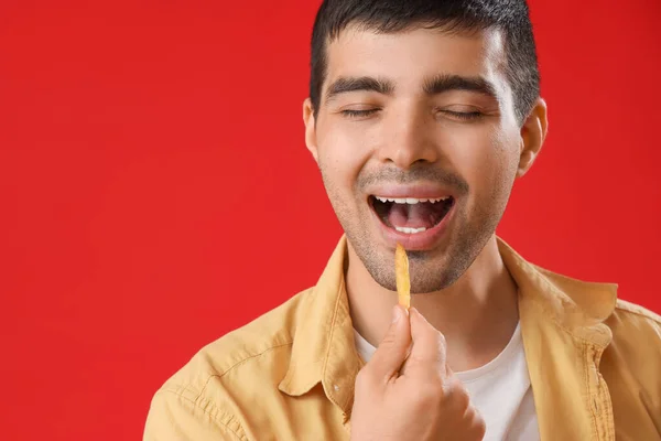 Young Man Eating French Fries Red Background Closeup — Stock Photo, Image