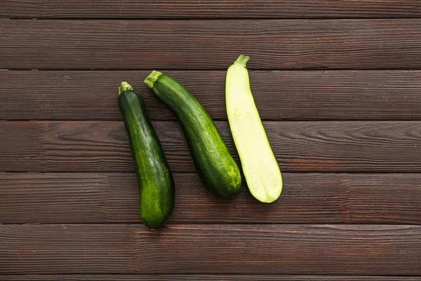 Fresh green zucchini on wooden background