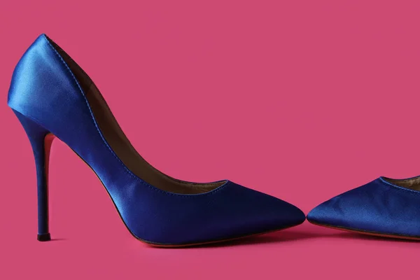 Stylish blue high heels on pink background