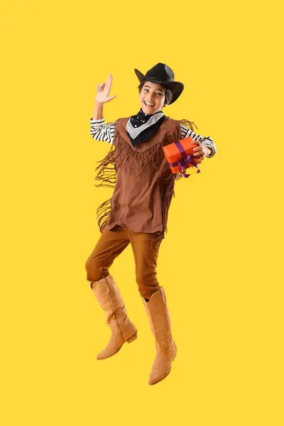 Little Boy Dressed Halloween Cowboy Gift Jumping Yellow Background — Stock Photo, Image