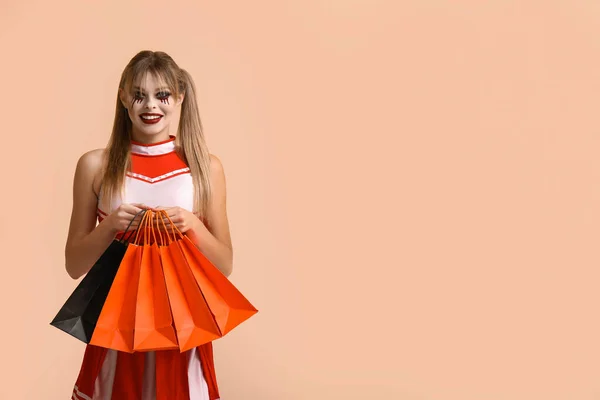 Young Woman Dressed Halloween Cheerleader Gift Bags Beige Background — Stock Photo, Image
