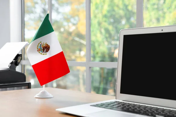オフィスのテーブルにメキシコの旗とラップトップ クローズアップ — ストック写真