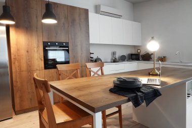 Ada masasında parlayan lambalar ve dizüstü bilgisayarlı modern mutfak.