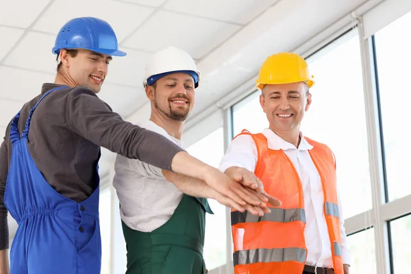 Team Male Builders Putting Hands Together Room — Stock Photo, Image