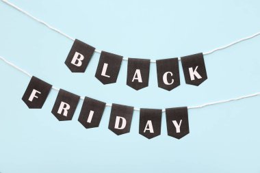 İp ve bayraklar mavi arkaplanda Kara Cuma metni ile