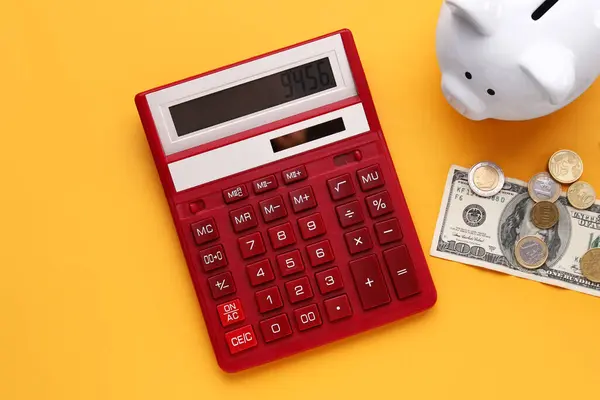Piggy Bank Money Calculator Orange Background — Stock Photo, Image