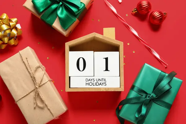 Countdown calendar with Christmas decorations and gift boxes on red background