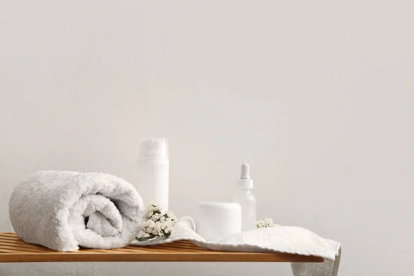 Set of spa supplies on table near white wall