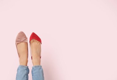 Renkli arka planda farklı ayakkabılı kadın bacakları