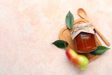 Cam kavanoz armut reçeli ahşap tahta ve kaşık ile grunge bej arka planda