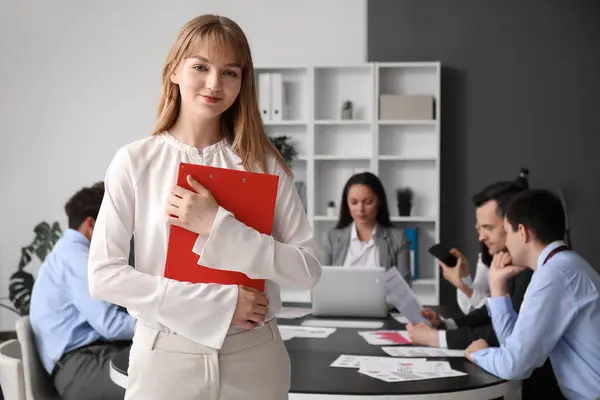 Female business consultant with clipboard working in office