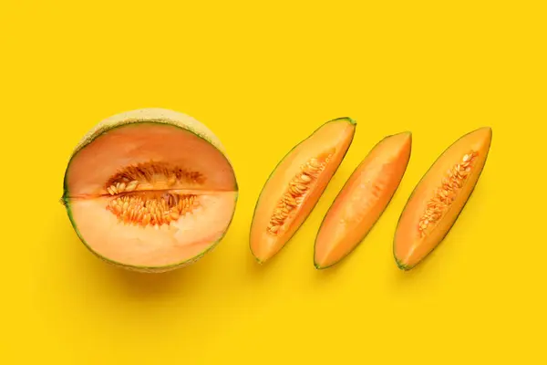 Sliced ripe melon on yellow background