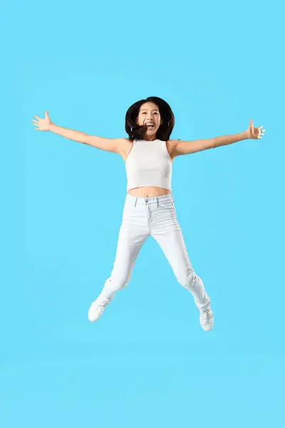 Jumping Asian Woman Blue Background — Stock Photo, Image