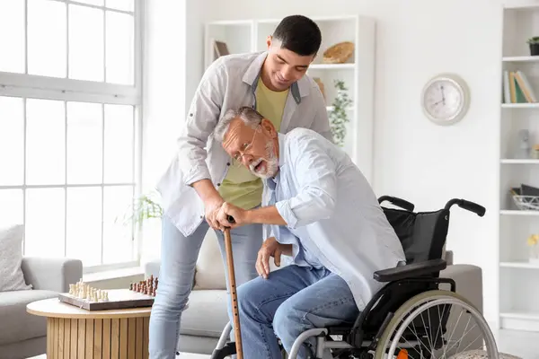 Senior Man Wheelchair Stick His Son Home — Stock Photo, Image