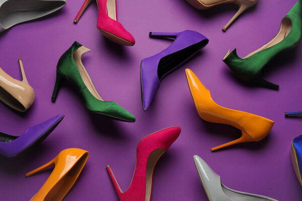 Different stylish high heels on purple background