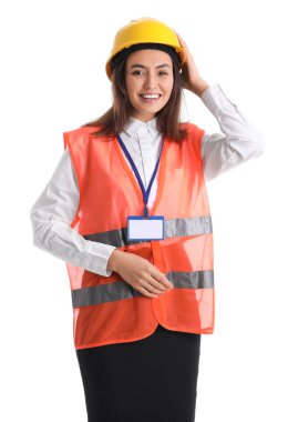 Female worker in vest and hardhat on white background