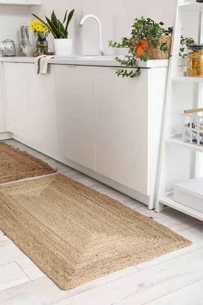Wicker rug on floor in light kitchen