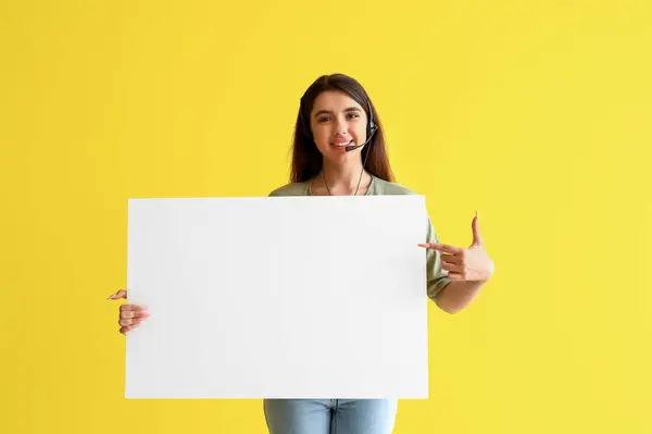 Female technical support agent with blank poster on yellow background