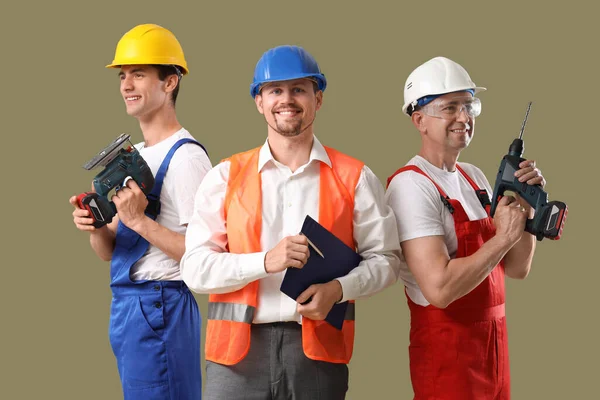 Team Male Builders Tools Green Background — Stock Photo, Image