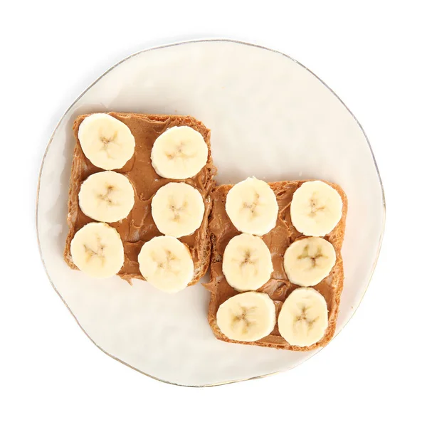 Plate of toasts with peanut butter and banana on white background