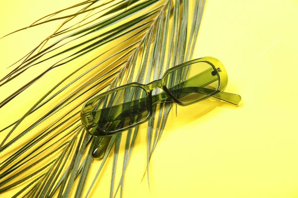 Stylish Sunglasses Palm Leaf Yellow Background — Stock Photo, Image