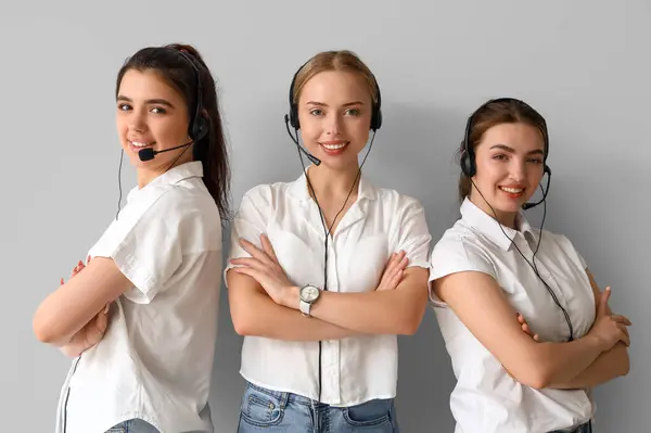 Female technical support agents on light background