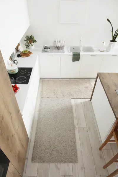 Soft rugs in interior of modern kitchen