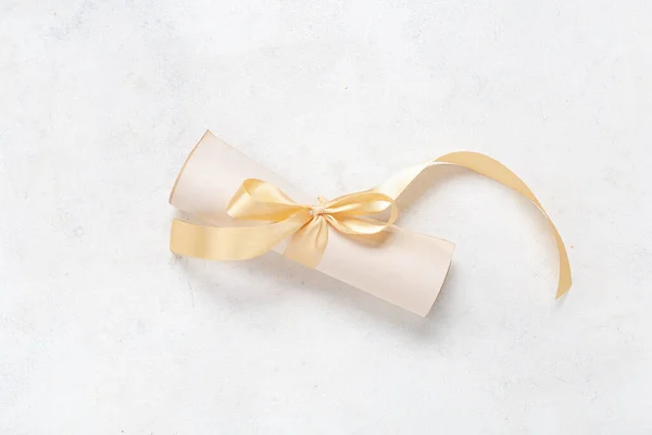 Roll Paper Tied Golden Ribbon White Background — Stock Photo, Image