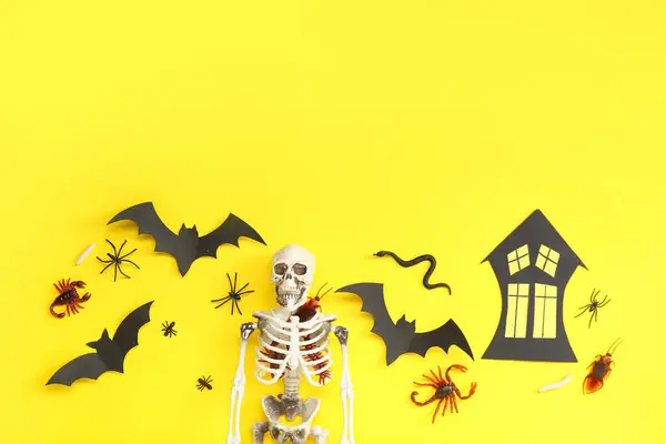 stock image Halloween composition with candy bugs, skeleton and bats on yellow background