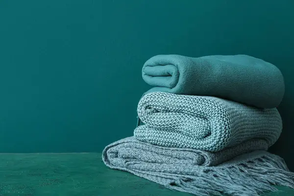 New soft folded blankets on green background