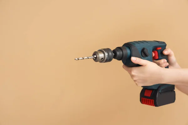 Female Hands Holding Rotary Hammer Drill Beige Background — Stock Photo, Image