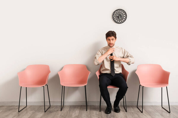 Male applicant waiting for job interview in room