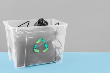 Renkli arka planda farklı ev aletleri olan geri dönüşüm kutusu