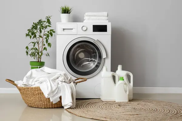 Washing Machine Bottles Detergent Basket Dirty Laundry Grey Wall — Stock Photo, Image