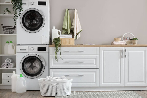 Laundry room with washing machines and white counters