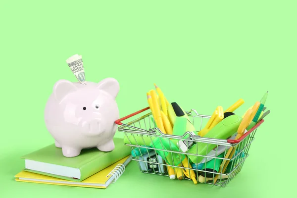 Shopping Basket Full Different Stationery Piggy Bank Money Green Background — Stock Photo, Image