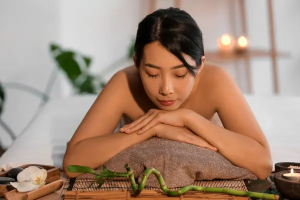 Pretty young Asian woman in spa salon
