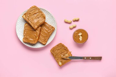 Pembe arka planda fıstık ezmeli tost tabağı