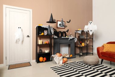 Cadılar Bayramı için kapı ve şömine raflarıyla dekore edilmiş oturma odasının içi.