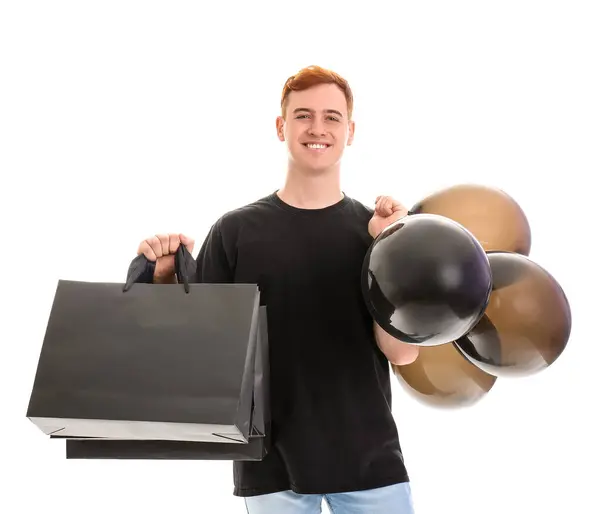 Glücklicher Junger Rothaariger Mann Mit Einkaufstaschen Und Luftballons Auf Weißem — Stockfoto