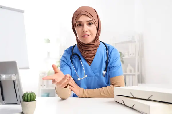 Female Muslim doctor in clinic