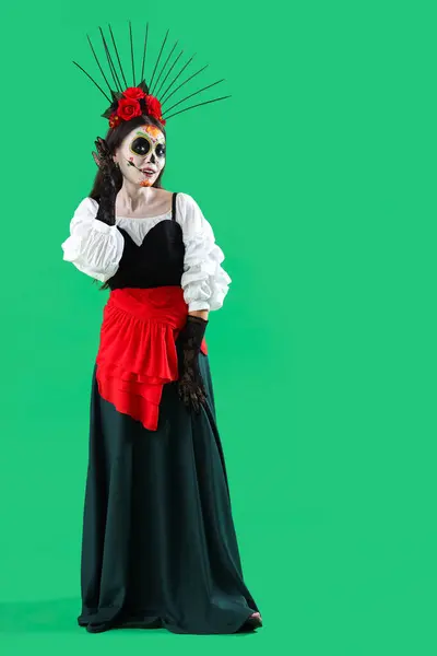 stock image Beautiful woman dressed for Halloween on green background