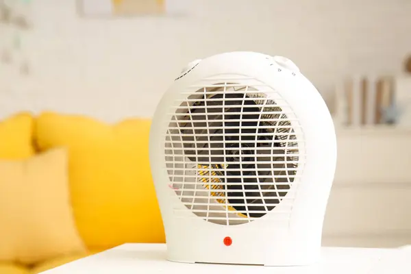 Electric fan heater on table in children's room