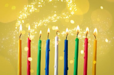 Hanukkah için renk arkaplanında mum yakılıyor, kapatılıyor