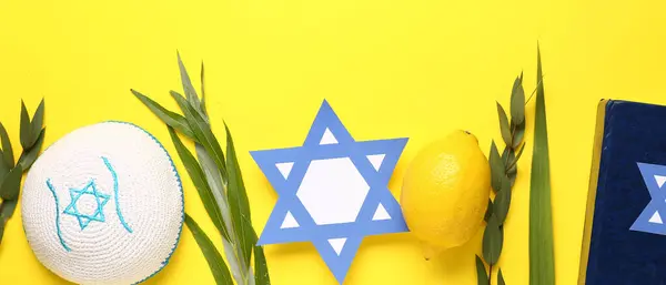 stock image Four species (lulav, hadas, arava, etrog) as Sukkot festival symbols, kippah, torah and paper David star on yellow background