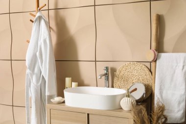 Banyo aksesuarlı lavabo lavabosu banyodaki masada.