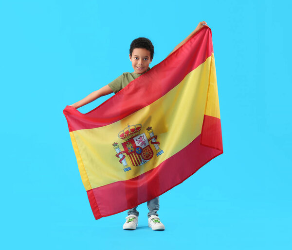 African-American little boy with flag of Spain on blue background