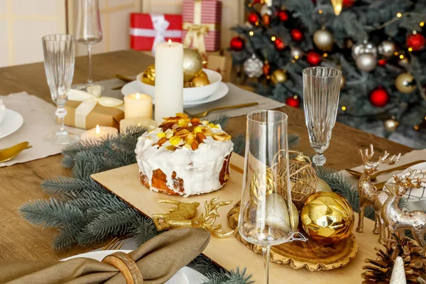 Christmas setting with cake on dining table in kitchen, closeup